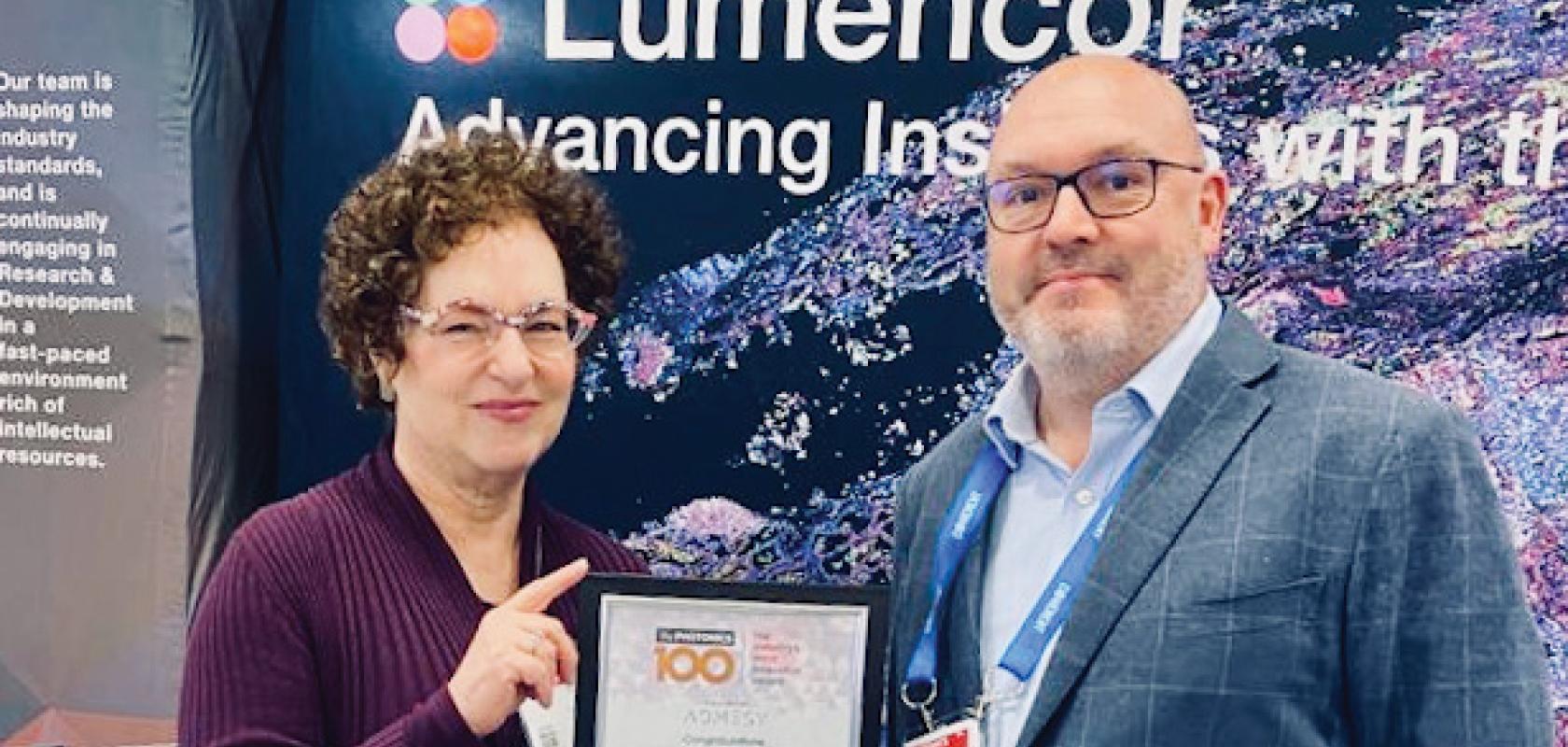 Lumencor Chief Commercial Officer Claudia Jaffe receives her Photonics100 certificate from Europa Science’s Mark Elliott at Photonics West 2023
