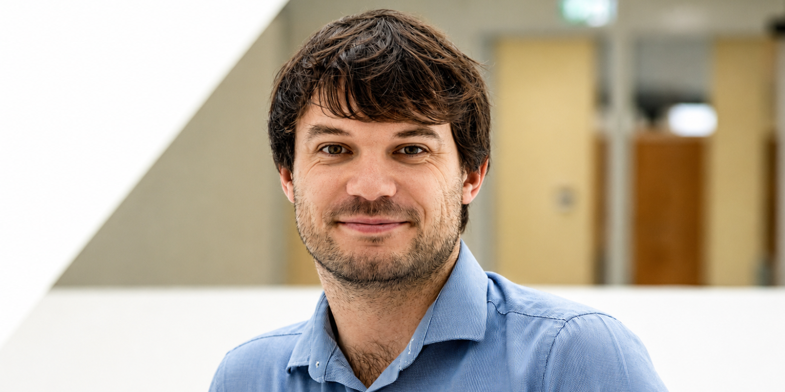 A white man with light brown hair wearing a blue shirt