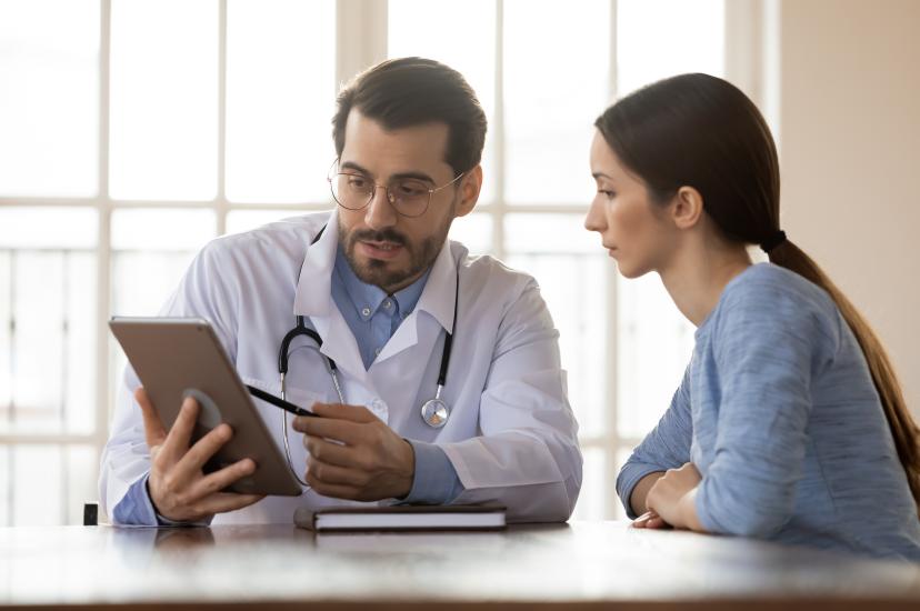 Doctor showing ipad to nurse