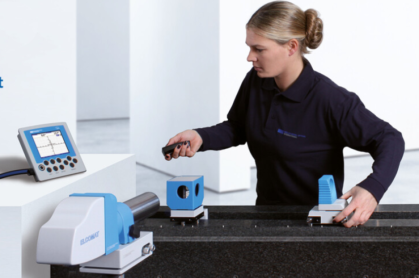 Woman in black outfit using Moller Wedel optical testing equipment