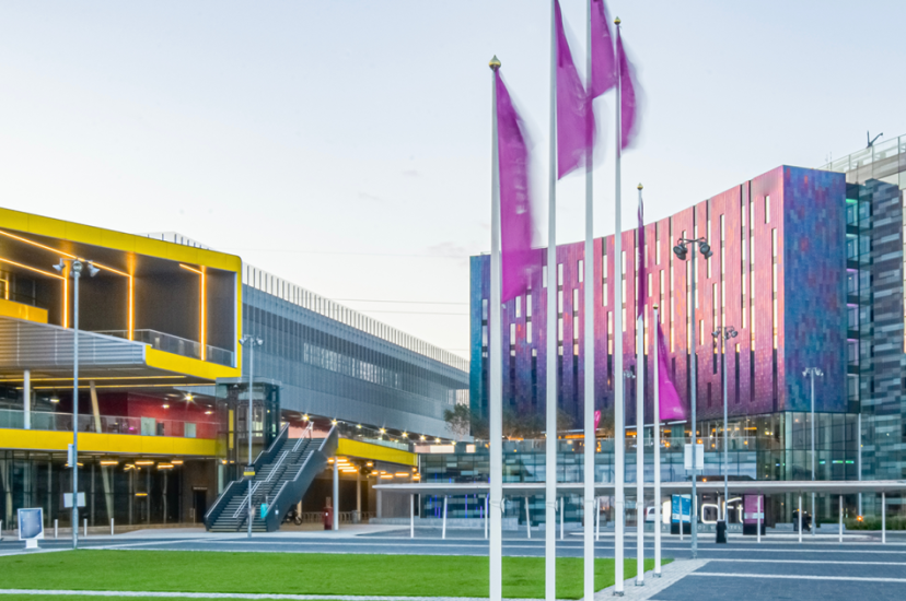 A yellow events centre entrance in the sunshine