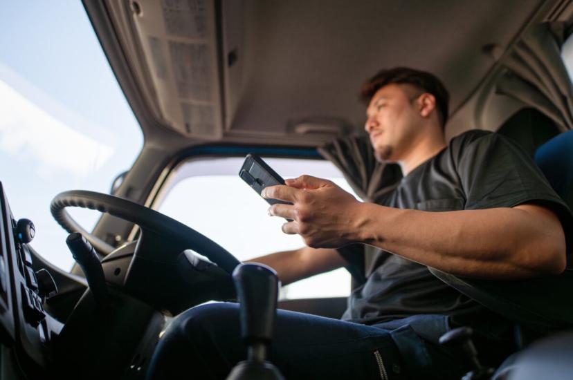 Truck driver driving while using phone