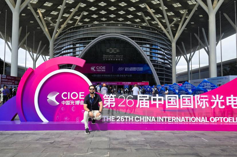 Dr Faisal Kamran sits on a sign outside the CIOE exhibition in Shenzhen, China