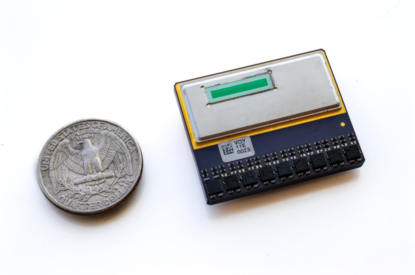 A small integrated circuit next to a quarter