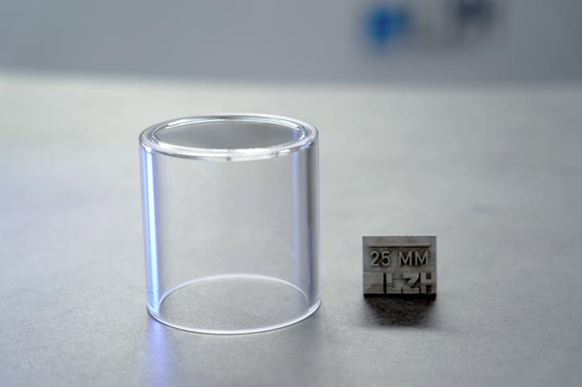 Thick-walled glass container next to 25mm measurement