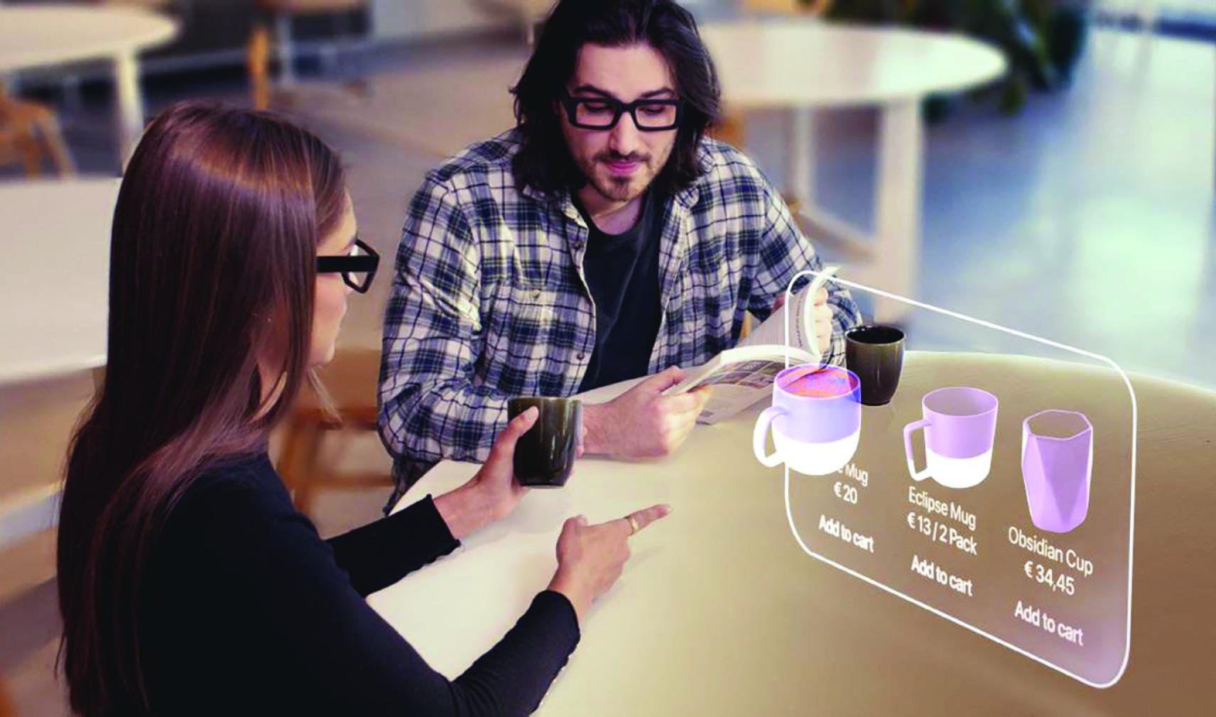 A man and a woman sit in front of an augmented reality screen