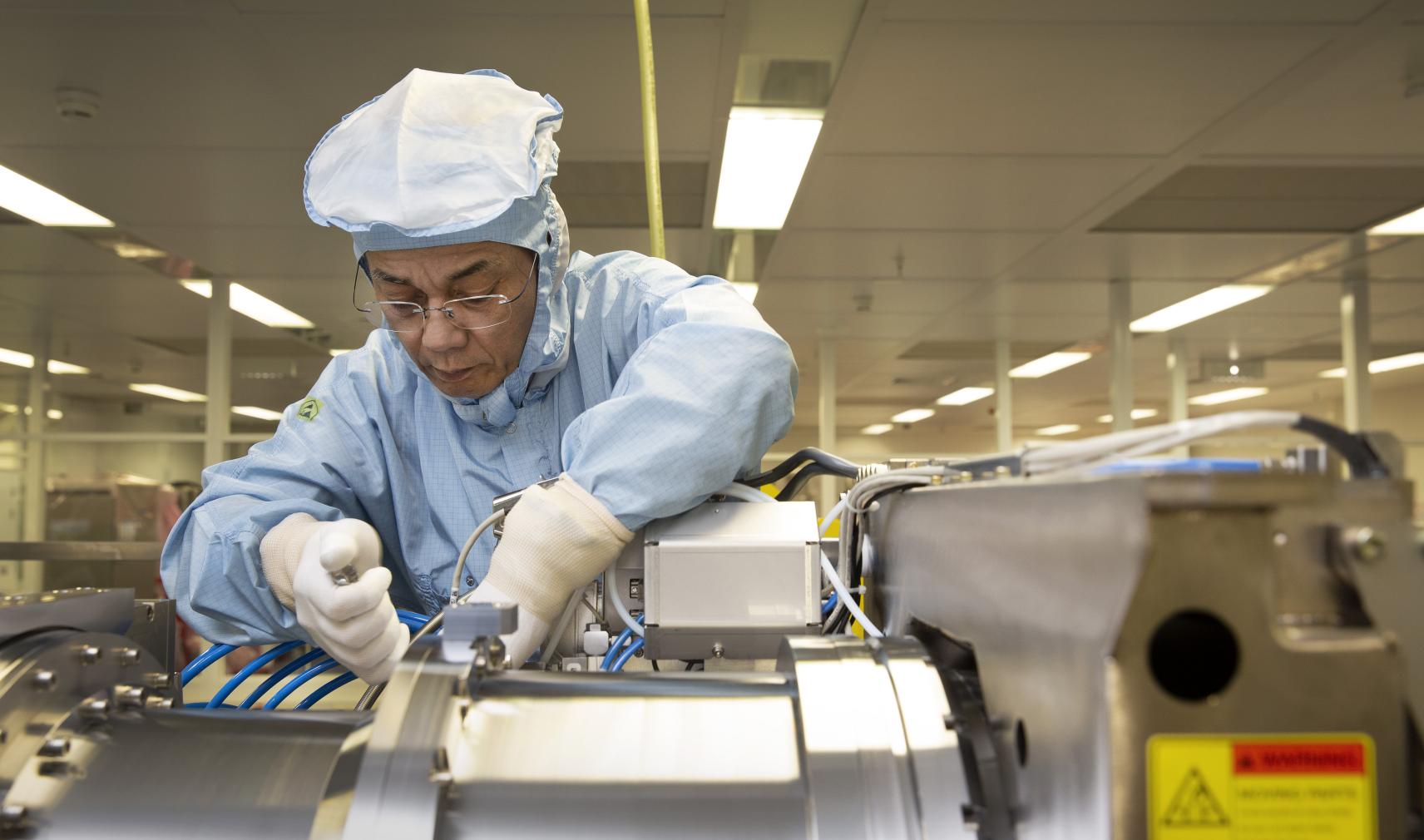 DUV engineer assembling ASML illumination module