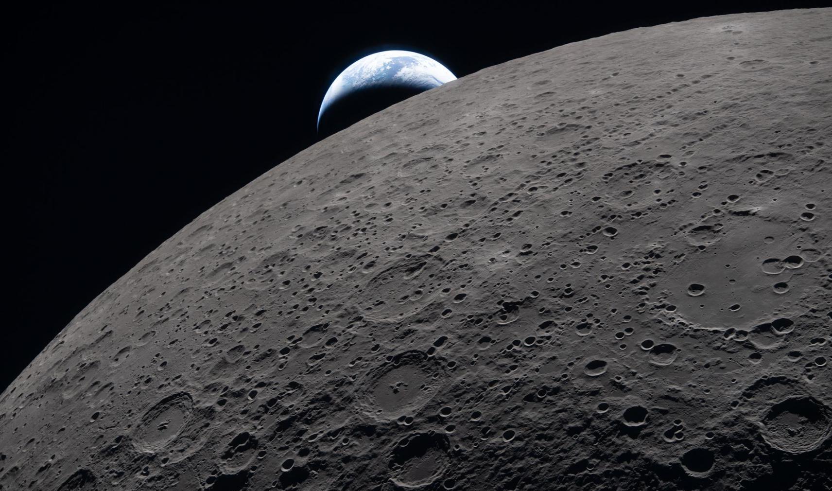 Lunar surface with a distant Earthset in the background