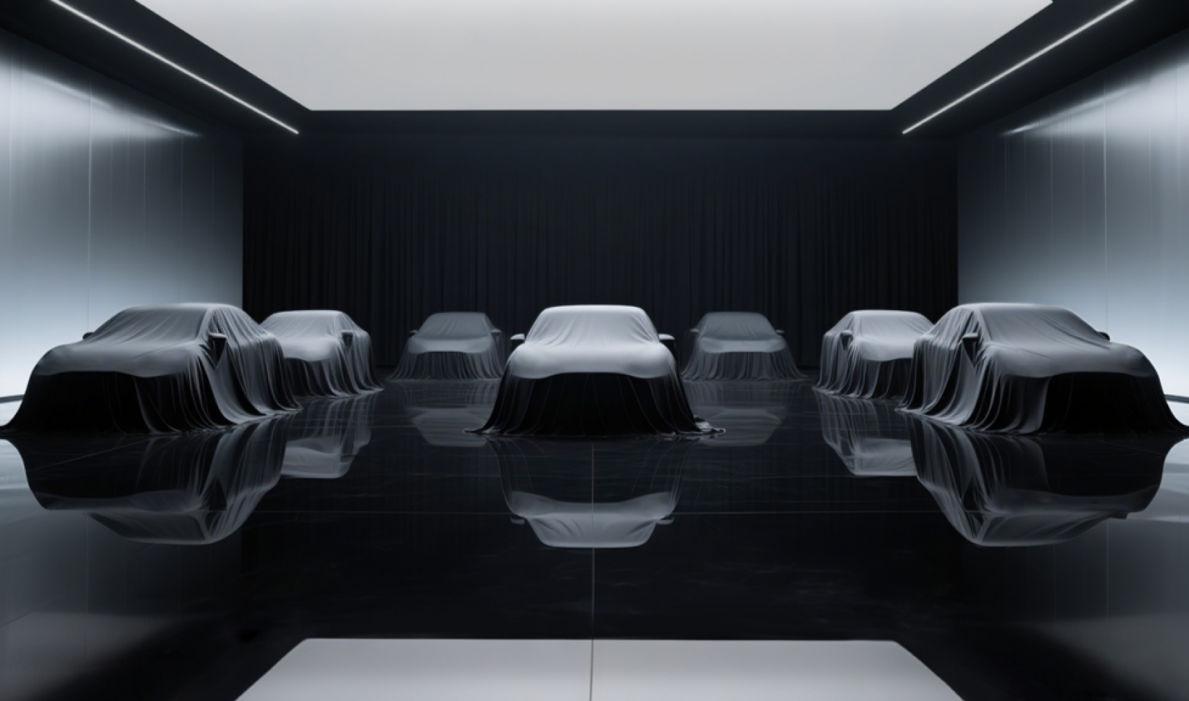 Stationary cars covered in dark sheets