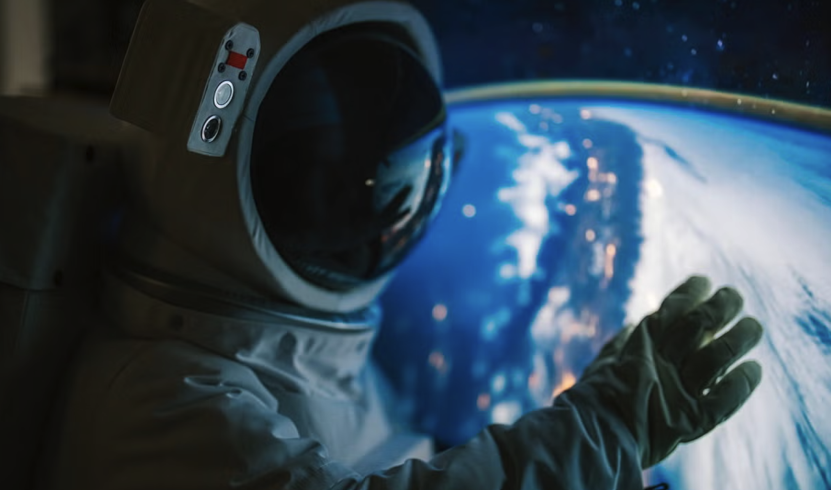Person in spacesuit in front of image of Earth