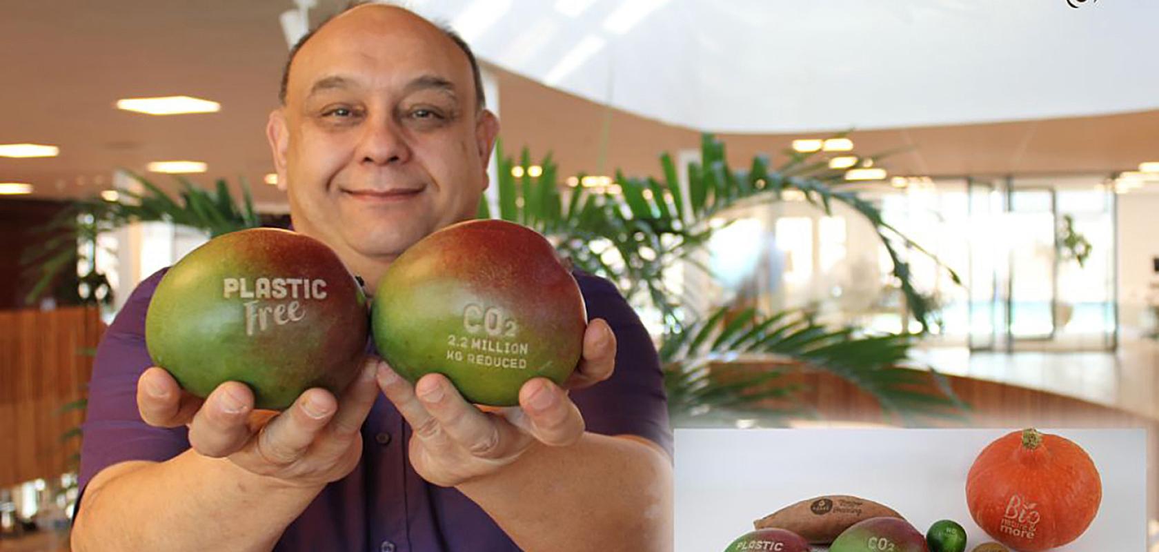 Man holding laser marked fruit