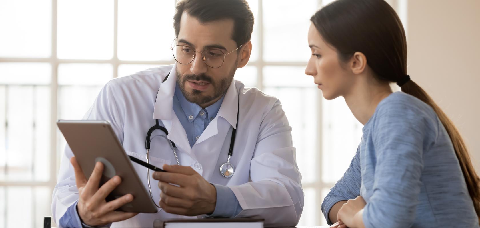 Doctor showing ipad to nurse