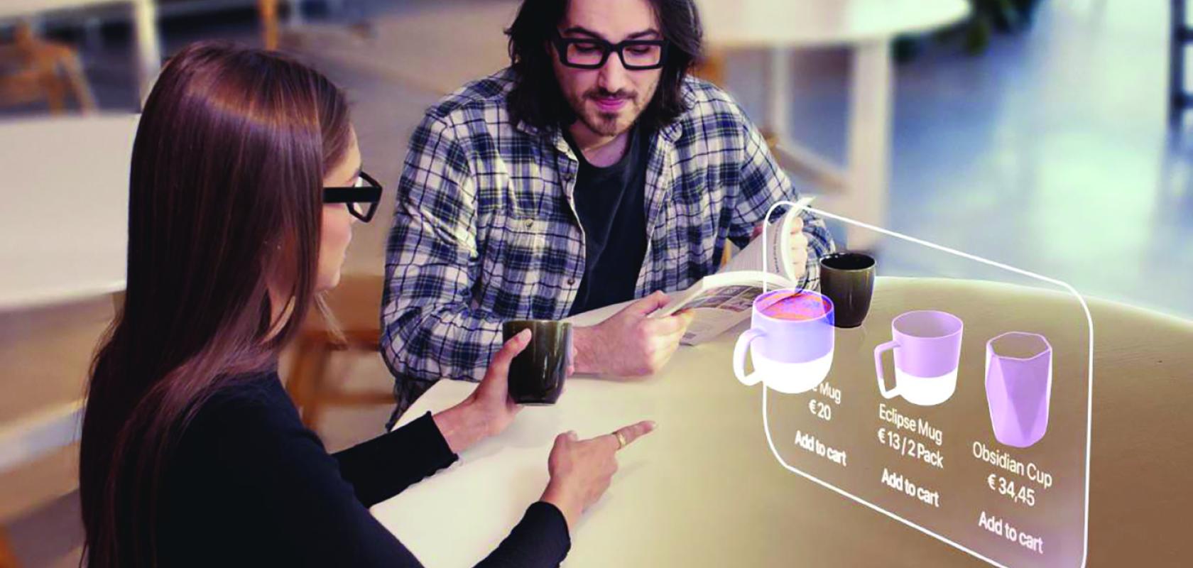 A man and a woman sit in front of an augmented reality screen