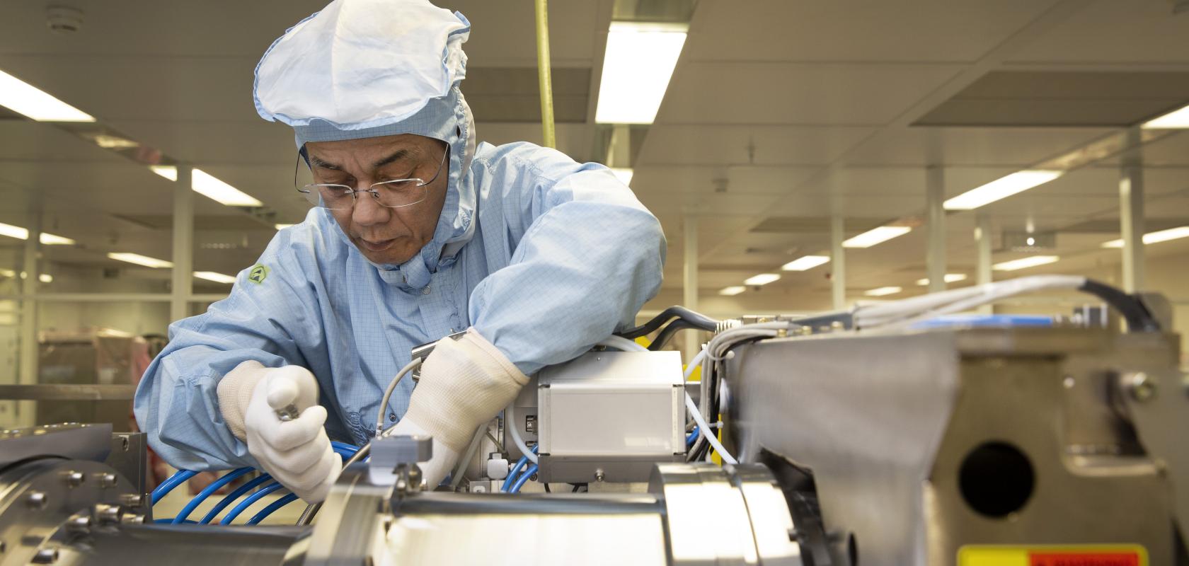 DUV engineer assembling ASML illumination module