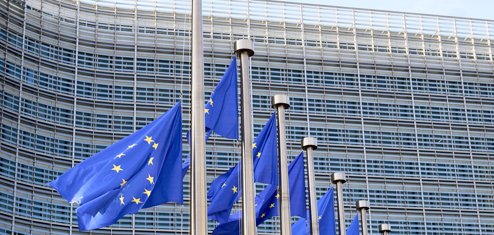 European flags waving in front of Berlaymont Building, the European Commission Headquarters