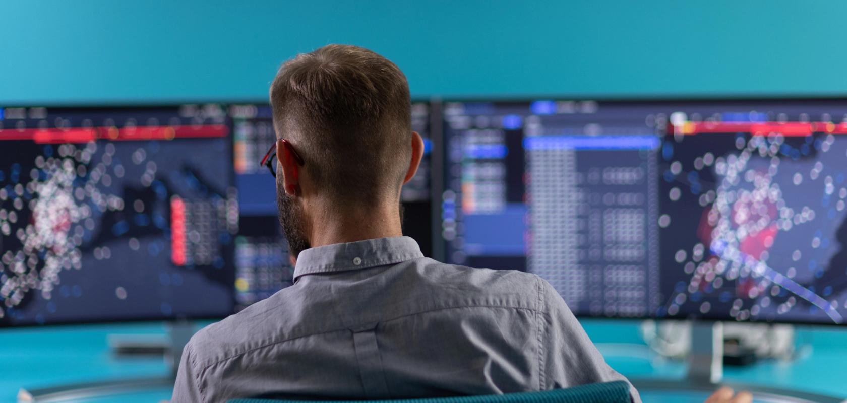 Employee sat in front of screens