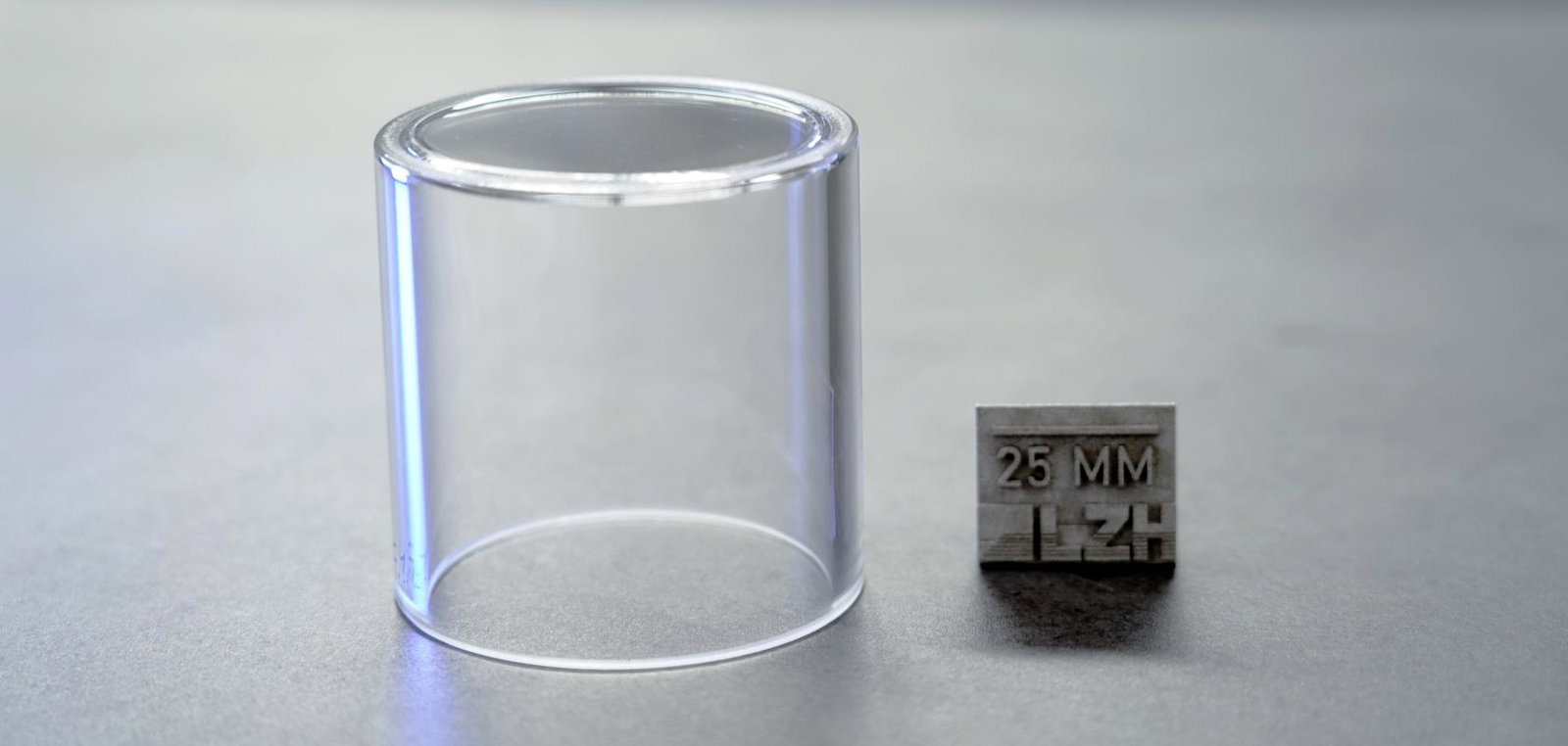 Thick-walled glass container next to 25mm measurement