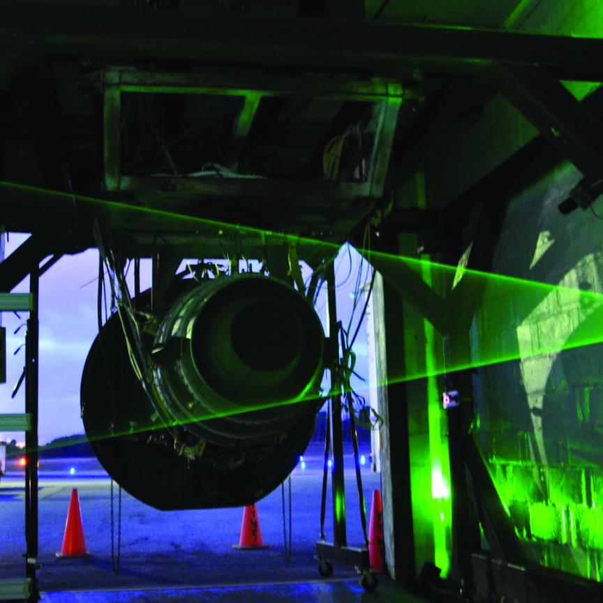 A jet engine exhaust being tested with a laser beam