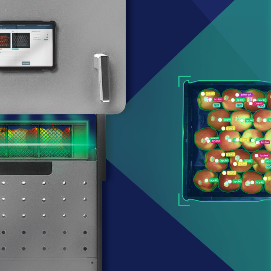A fruit scanner machine examines a box of apples