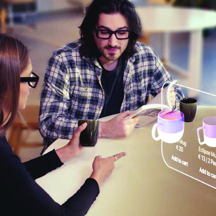 A man and a woman sit in front of an augmented reality screen