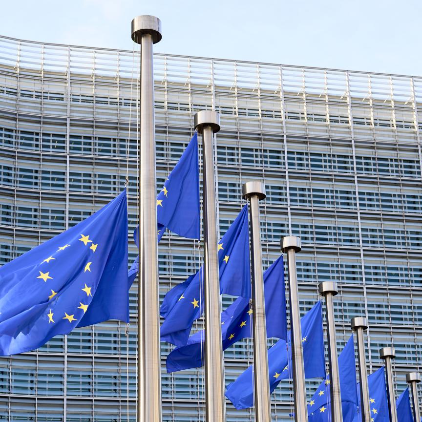 European flags waving in front of Berlaymont Building, the European Commission Headquarters