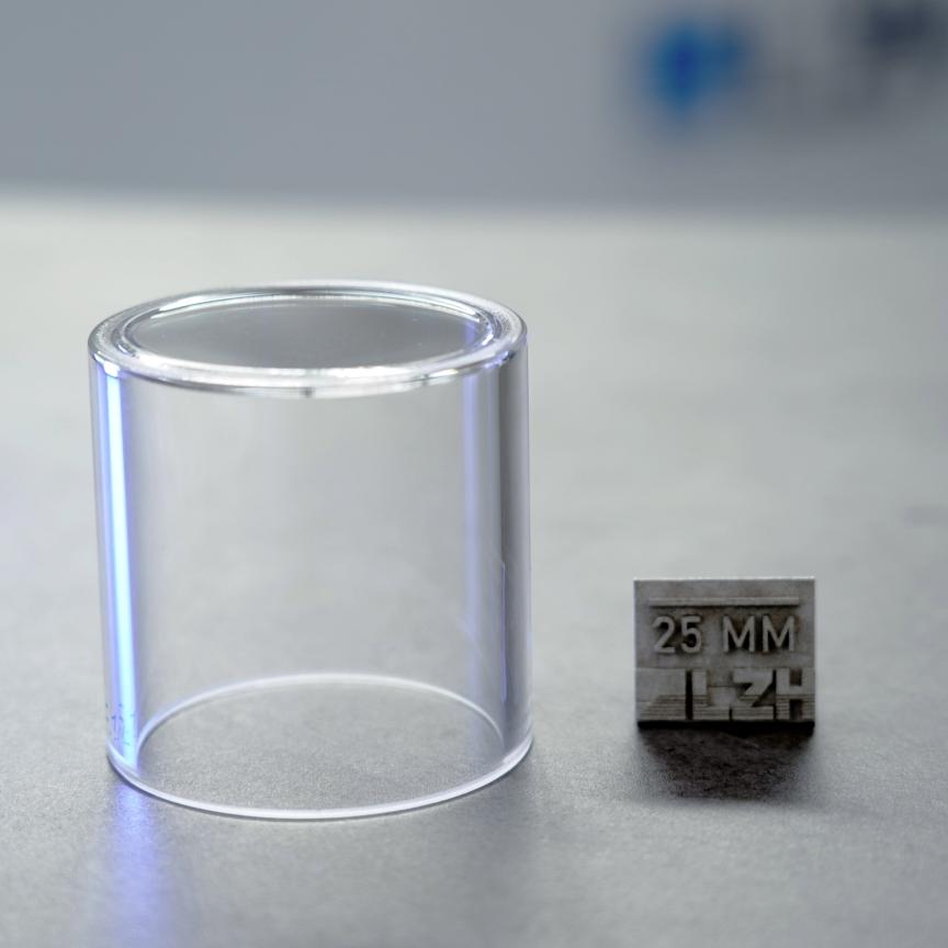 Thick-walled glass container next to 25mm measurement