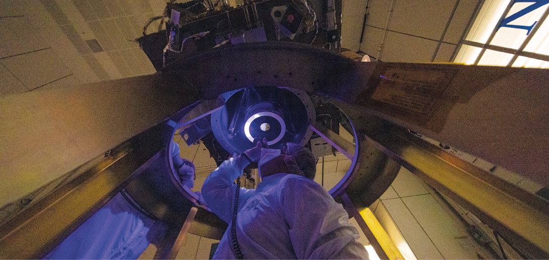 An engineer installs the Draco camera aboard Nasa's DART spacecraft