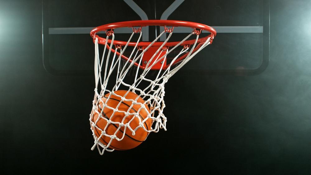 A basketball flies through the net